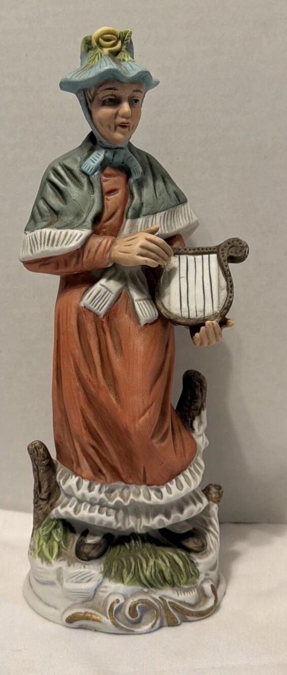 Vintage Porcelain Figurine of Old Woman Playing a Harp. 11 Inches Tall.